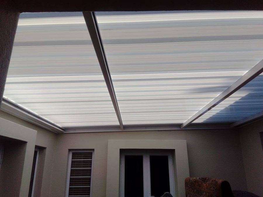 Translucent polycarbonate patio roof sheeting installed over an outdoor living area in Pretoria