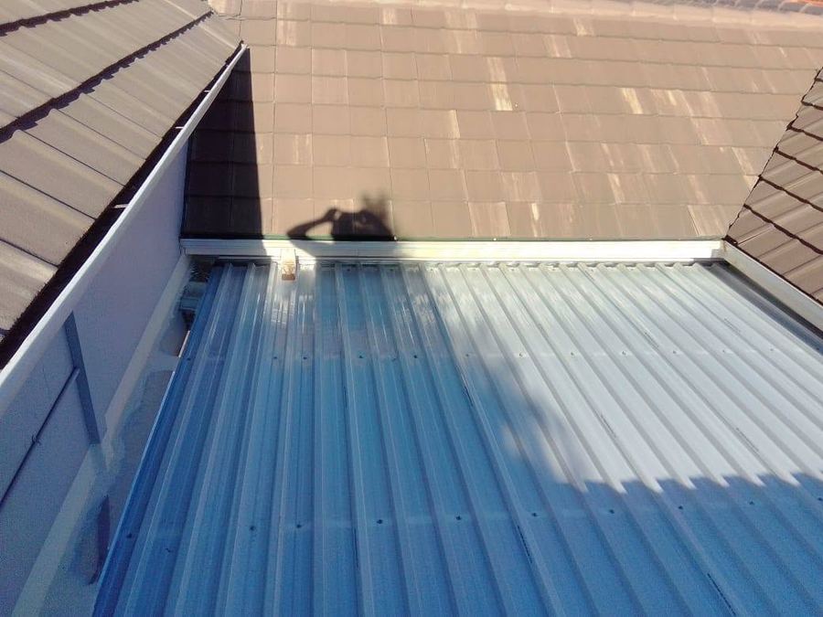 Roof tiling and gutter maintenance work viewed from above in Pretoria